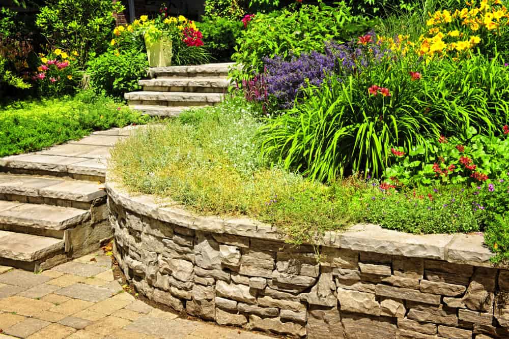 Natural stone landscaping Natural stone landscaping in home garden with stairs and retaining walls