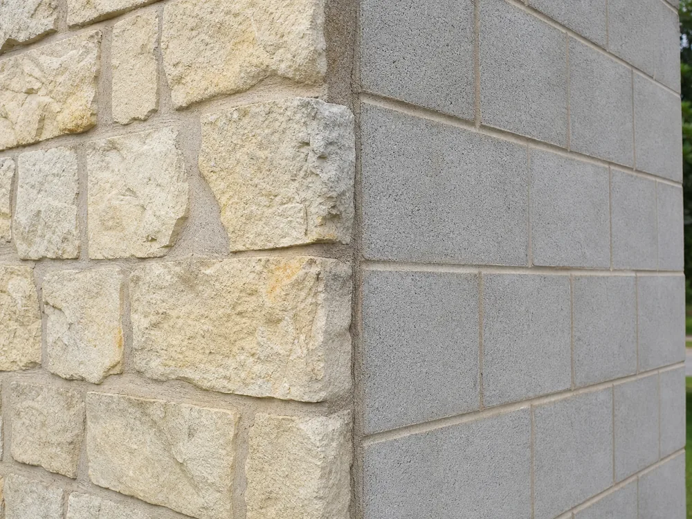 Retaining wall cross section showing gravel backfill, fabric, and drain pipe at the base
